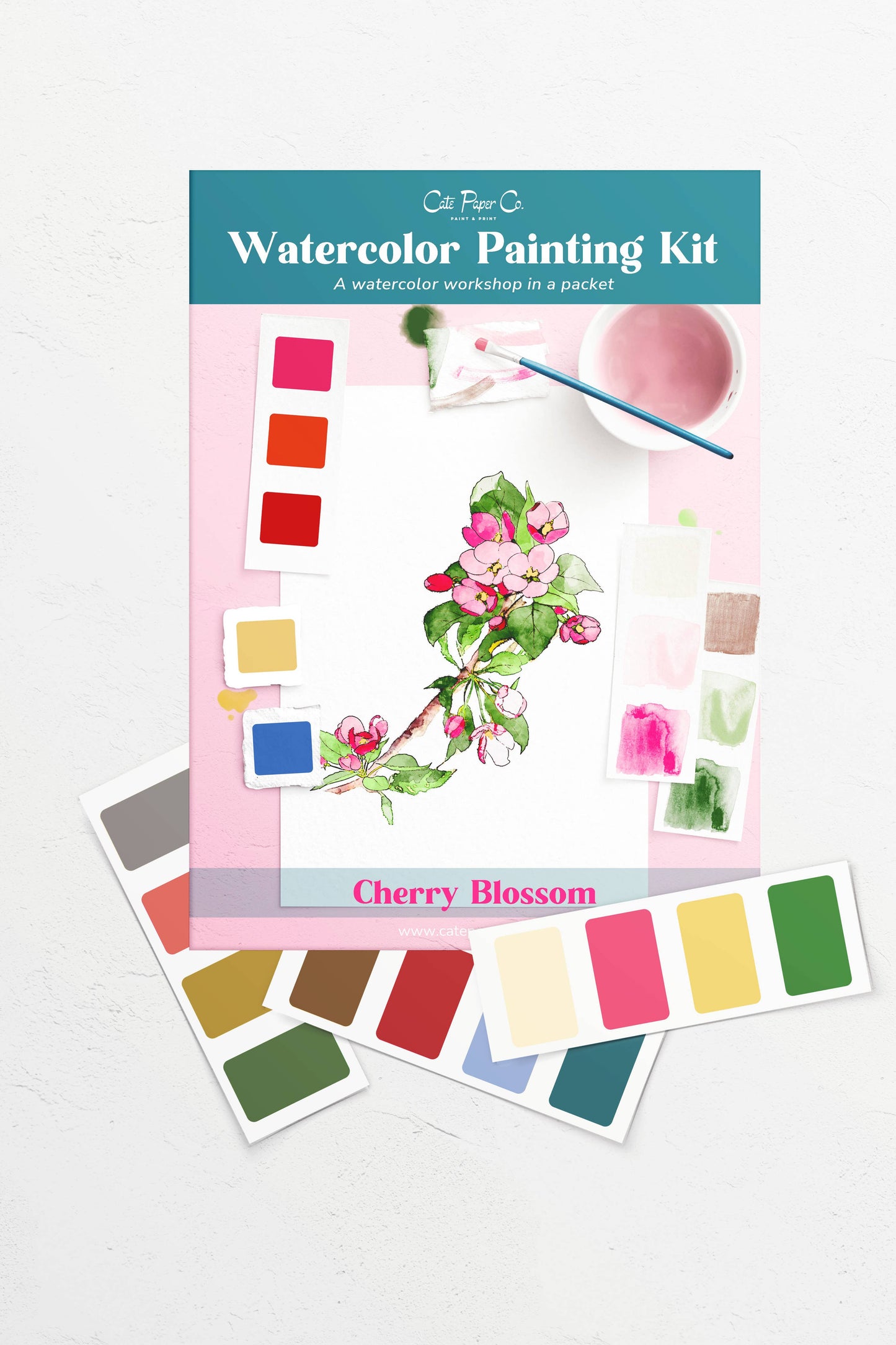 Watercolor painting kit with cherry blossom design and color swatches on a white background