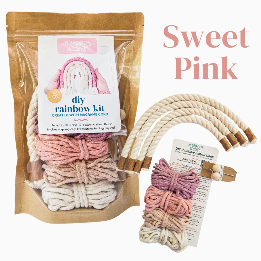 Sweet pink DIY rainbow macrame kit on white background