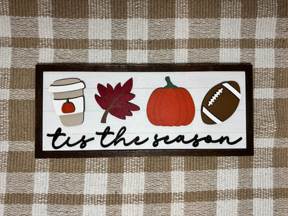 Finished wooden fall home decor featuring a pumpkin spice latte, leaf, pumpkin, football, and the words tis the season.